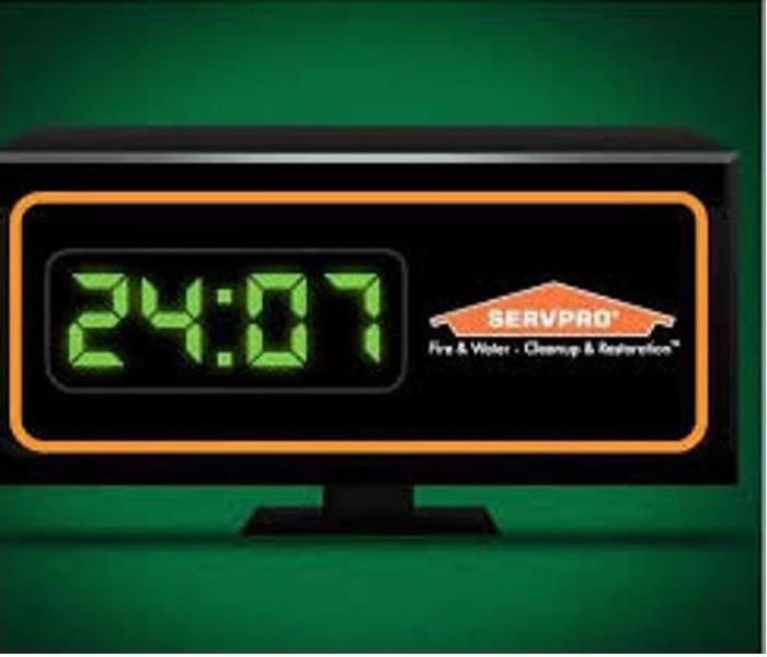 Digital clock showing 24:07 next to SERVPRO logo indicating 24/7 services
